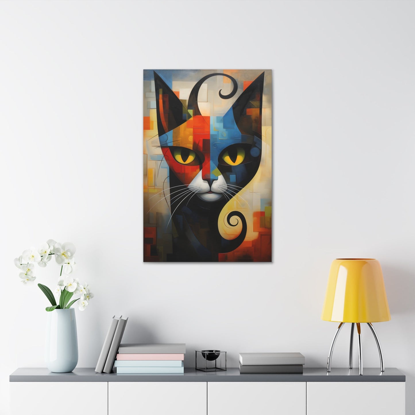 Vertical-oriented wall art: A vibrant cubist-style portrait of a cat, featuring a geometric composition with bold shapes and colors. The cat's eyes are bright yellow, set against a dynamic background of intersecting blocks in shades of red, blue, orange, and yellow.