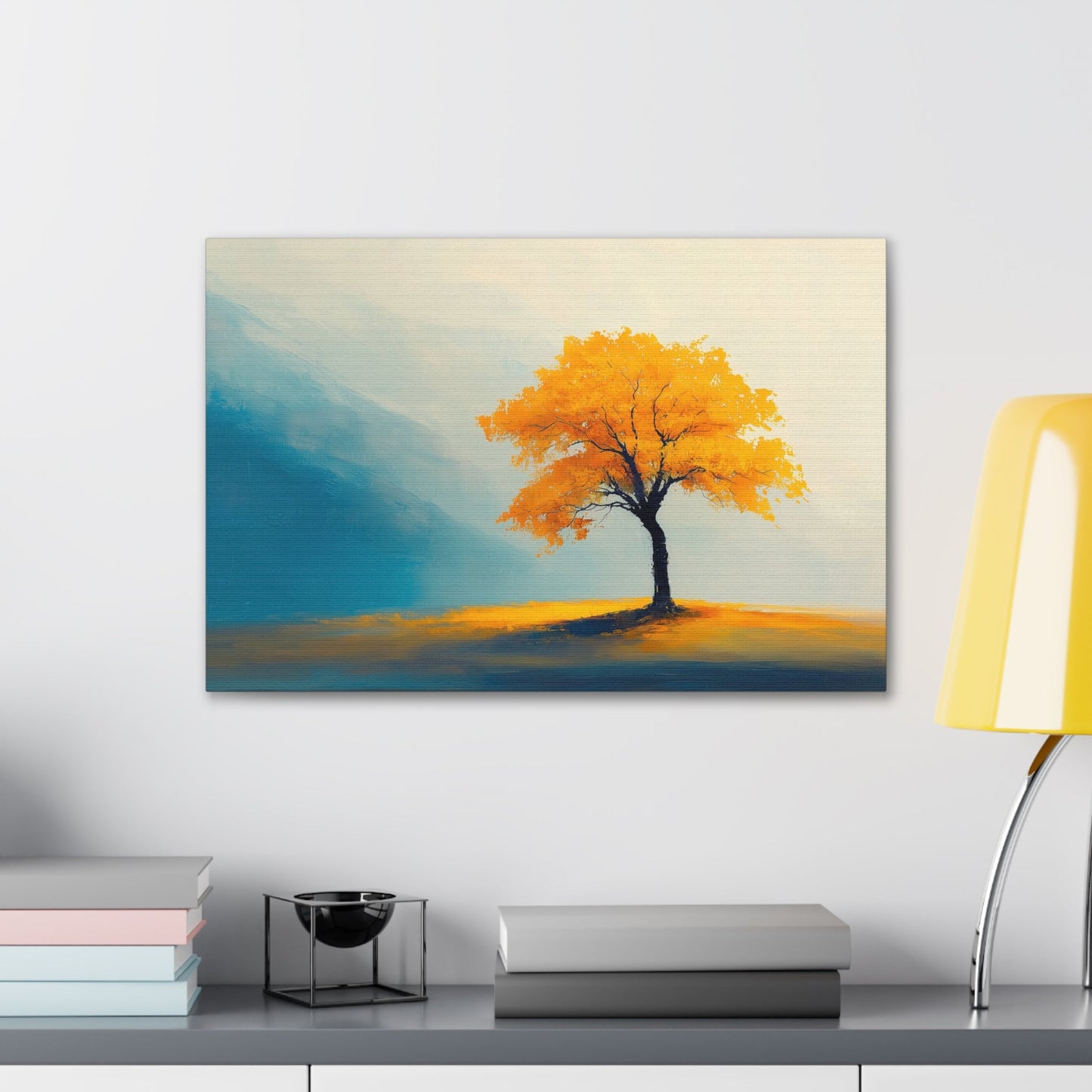 Horizontal-oriented wall art: Artwork titled Autumn’s Glow from the Ethereal Horizons collection, featuring a vibrant golden tree standing alone in a serene, misty landscape. The composition combines warm amber tones with soft teal hues, evoking tranquility and the timeless beauty of autumn.