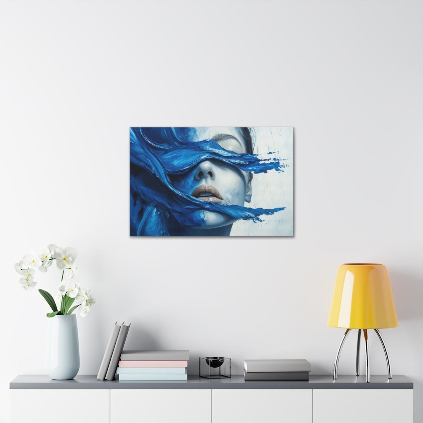 Horizontal-oriented wall art "Tides of the Mind" A surreal portrait of a woman's face partially obscured by flowing waves of cobalt blue paint. The image evokes a sense of introspection and calm, blending realistic features with abstract, fluid movement.