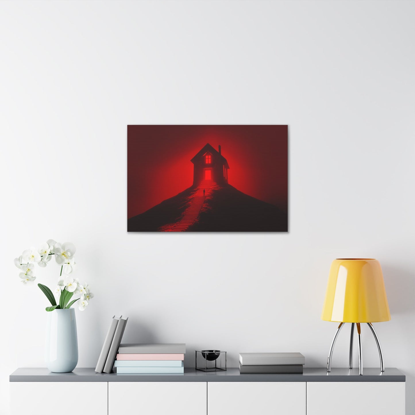 Horizontal-oriented wall art: Artwork titled Crimson Ascent from the Ruby Realms collection, featuring a glowing red house atop a hill with a solitary figure ascending a shadowed staircase. The piece creates an eerie and surreal atmosphere with its intense red glow and dramatic contrast.