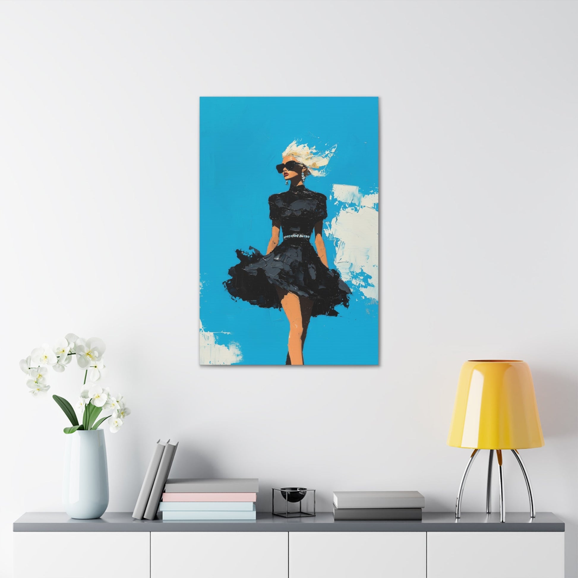 Vertical-oriented wall art: "Black Enigma II." A confident woman walks gracefully in a textured black dress, her wind-blown hair illuminated against a vibrant cerulean sky. The bold palette knife technique and striking contrasts emphasize empowerment and elegance.