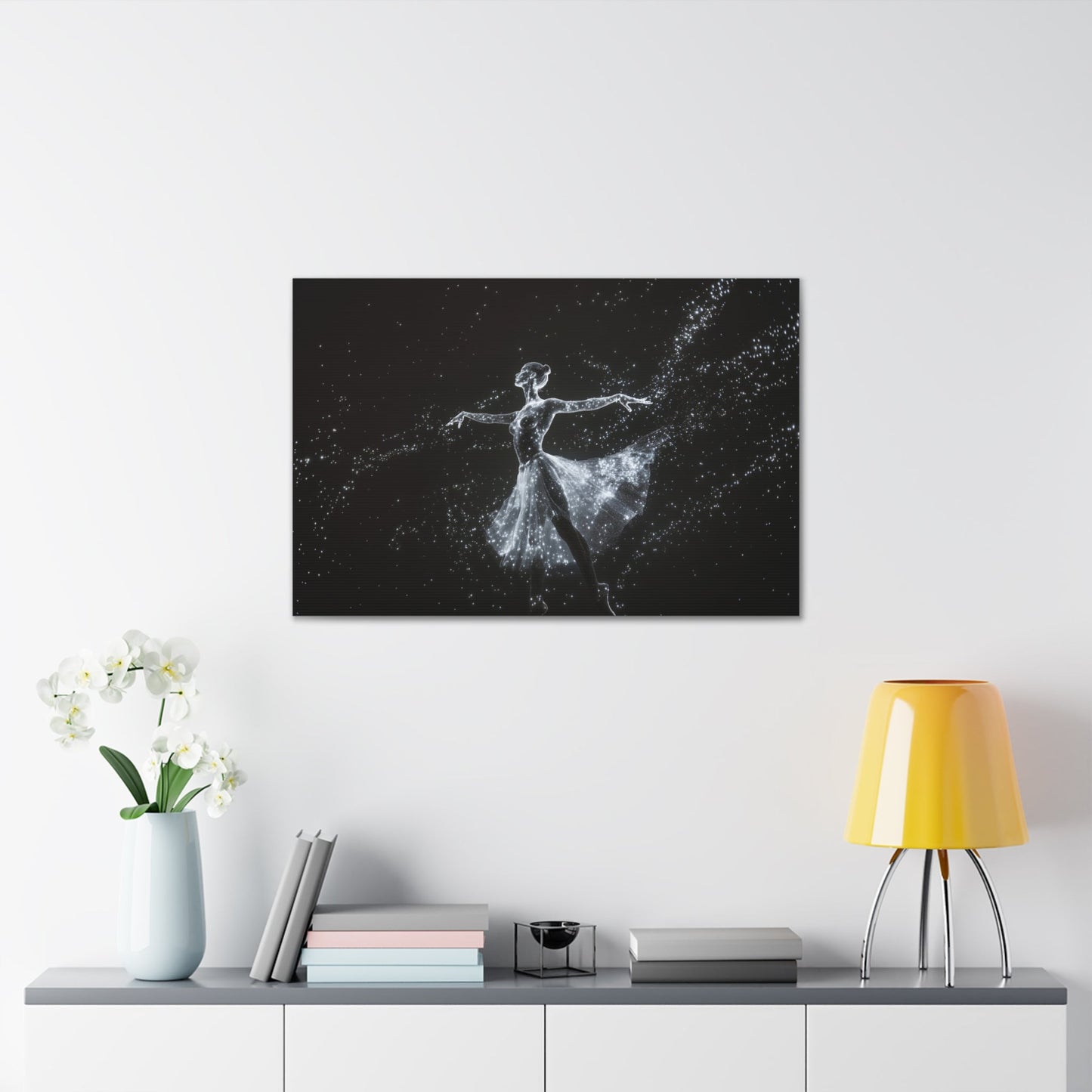 Horizontal-oriented wall art: "Cosmic Ballet III" A ballerina made of radiant, star-like dots gracefully dances against a dark, star-filled backdrop, her silhouette shining in monochromatic light. The scene captures the ethereal beauty of a cosmic dance, with stars trailing from her flowing skirt.