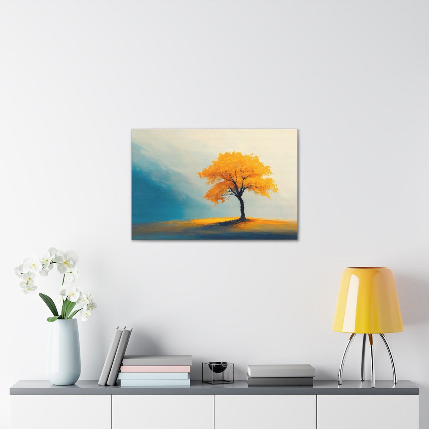 Horizontal-oriented wall art: Artwork titled Autumn’s Glow from the Ethereal Horizons collection, featuring a vibrant golden tree standing alone in a serene, misty landscape. The composition combines warm amber tones with soft teal hues, evoking tranquility and the timeless beauty of autumn.