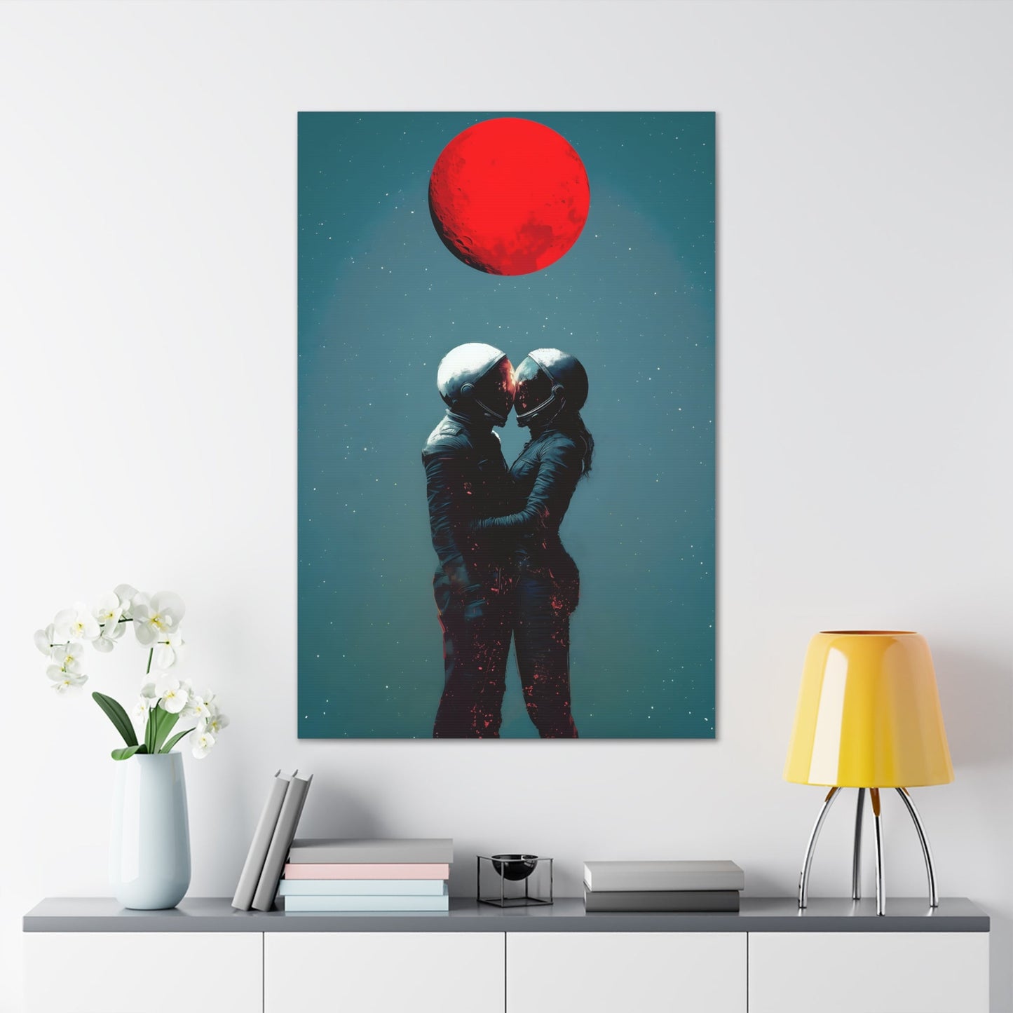 Vertical-oriented wall art: "Galactic Romance IV" depicts two astronauts embracing under a glowing red moon, their helmets gently touching as they share a moment of intimacy in space. The starry background contrasts with the fiery red moon, emphasizing the romantic and cosmic connection between the figures.