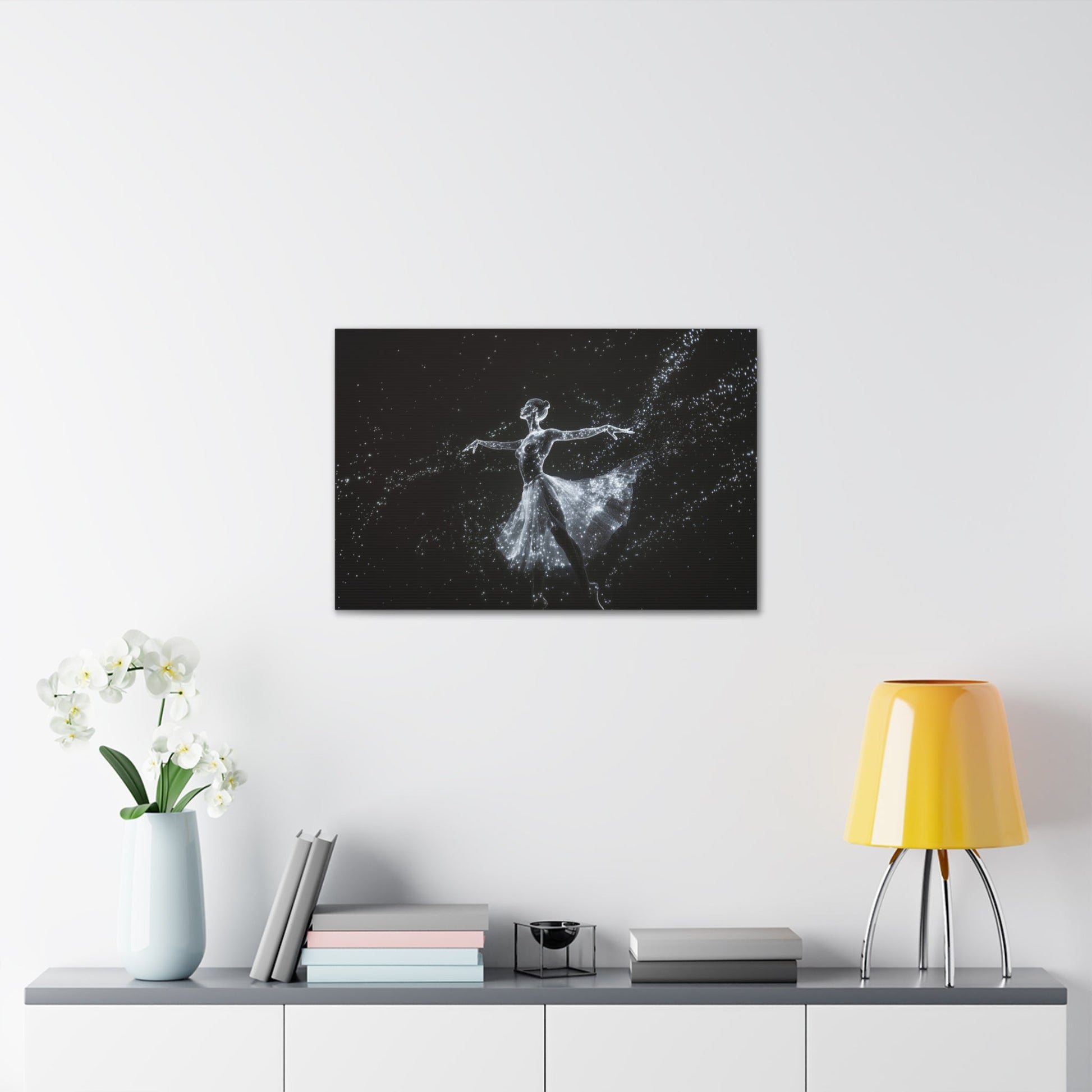 Horizontal-oriented wall art: "Cosmic Ballet III" A ballerina made of radiant, star-like dots gracefully dances against a dark, star-filled backdrop, her silhouette shining in monochromatic light. The scene captures the ethereal beauty of a cosmic dance, with stars trailing from her flowing skirt.