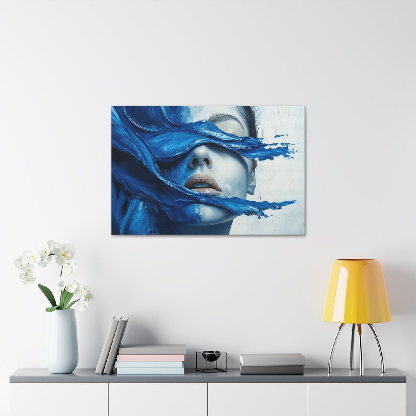 Horizontal-oriented wall art "Tides of the Mind" A surreal portrait of a woman's face partially obscured by flowing waves of cobalt blue paint. The image evokes a sense of introspection and calm, blending realistic features with abstract, fluid movement.