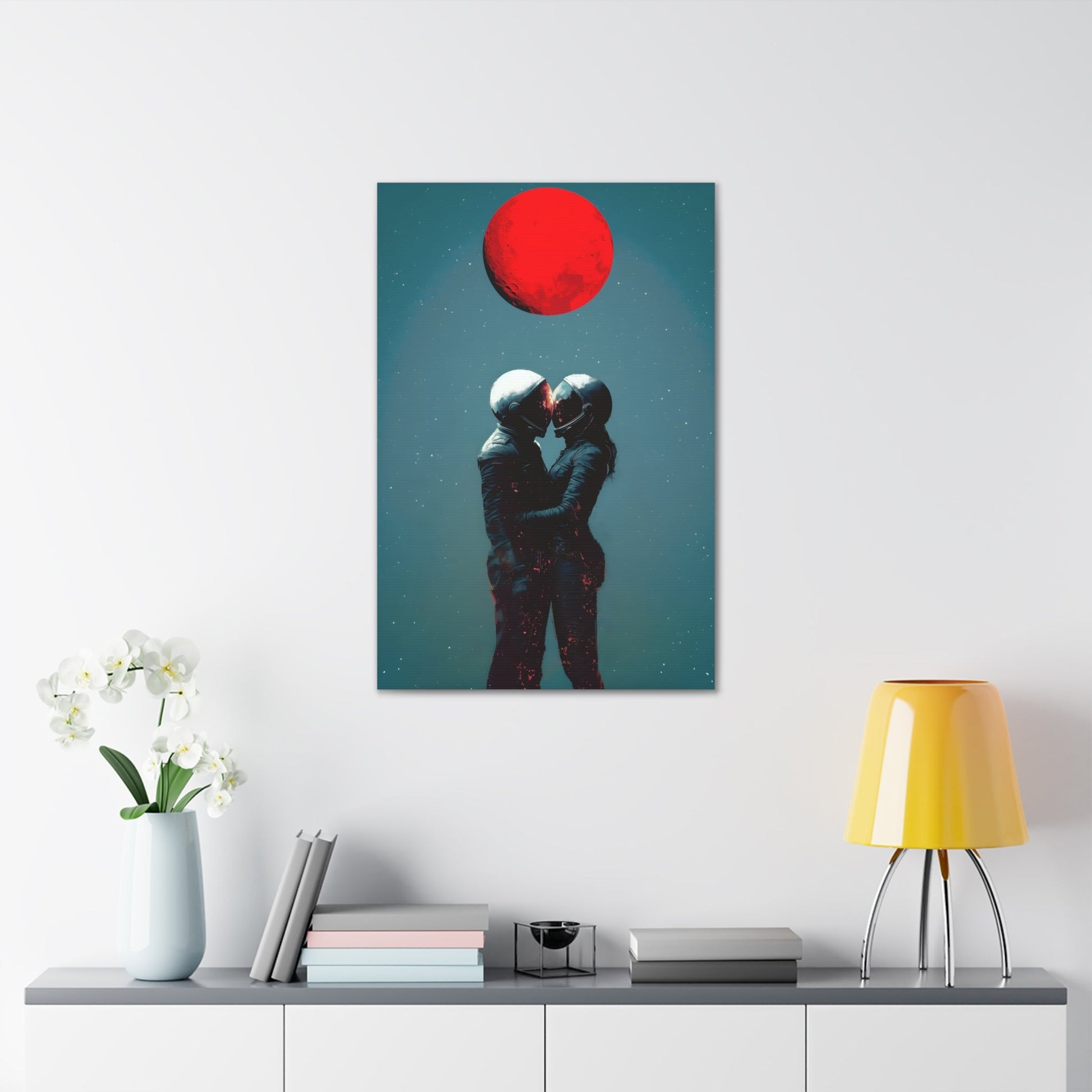 Vertical-oriented wall art: "Galactic Romance IV" depicts two astronauts embracing under a glowing red moon, their helmets gently touching as they share a moment of intimacy in space. The starry background contrasts with the fiery red moon, emphasizing the romantic and cosmic connection between the figures.