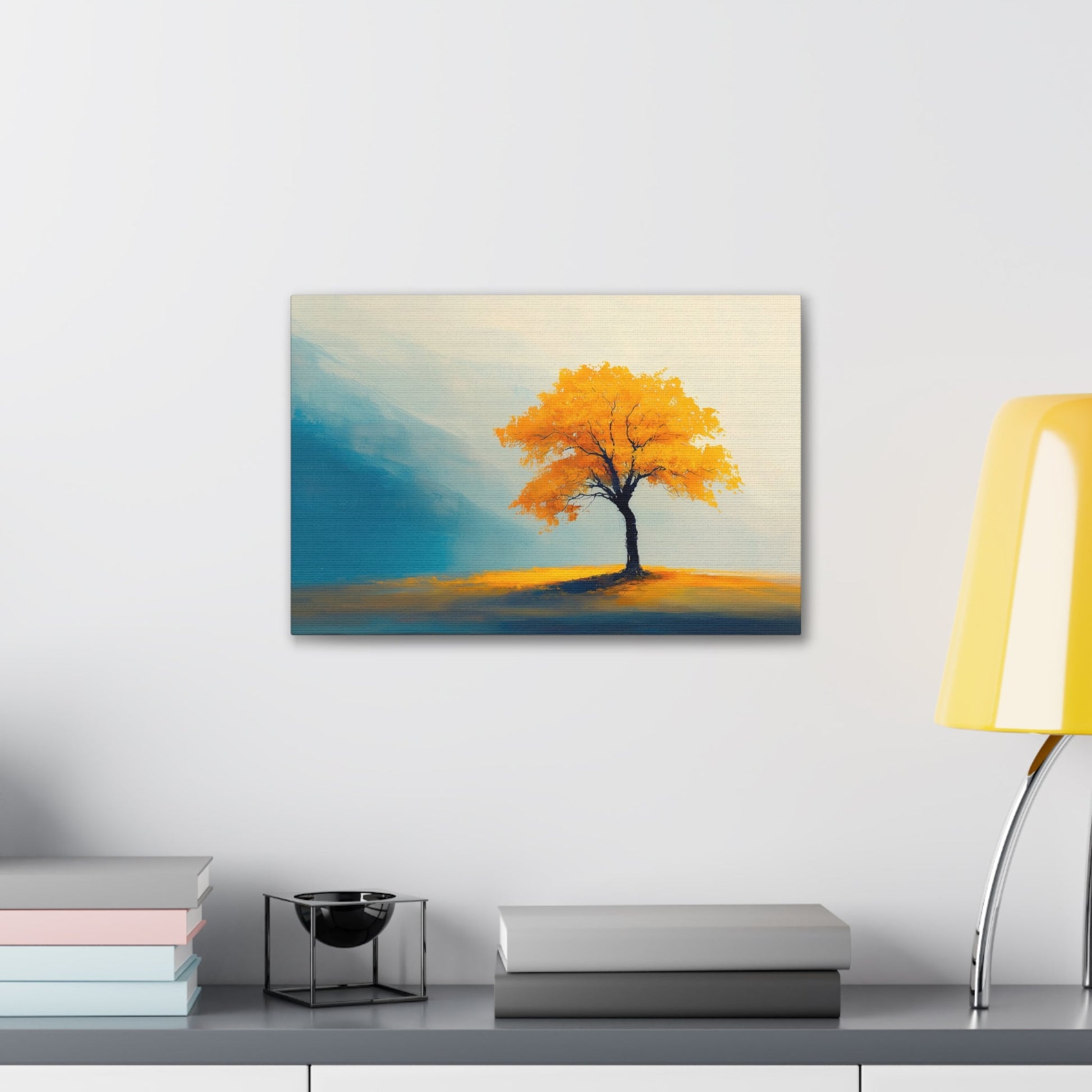 Horizontal-oriented wall art: Artwork titled Autumn’s Glow from the Ethereal Horizons collection, featuring a vibrant golden tree standing alone in a serene, misty landscape. The composition combines warm amber tones with soft teal hues, evoking tranquility and the timeless beauty of autumn.