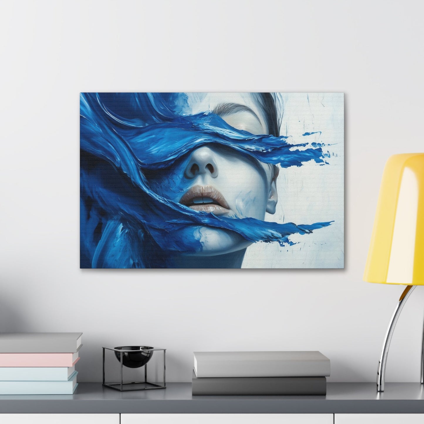 Horizontal-oriented wall art "Tides of the Mind" A surreal portrait of a woman's face partially obscured by flowing waves of cobalt blue paint. The image evokes a sense of introspection and calm, blending realistic features with abstract, fluid movement.